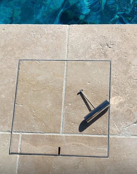 Hidden manhole cover in limestone