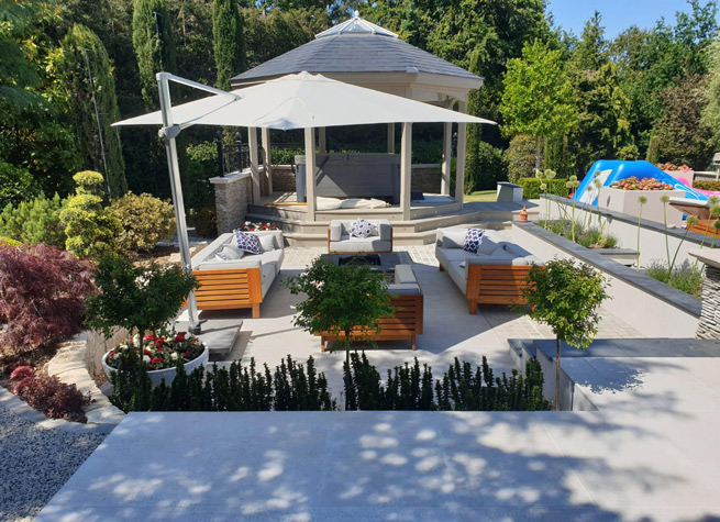 beautiful sunken garden with furniture and parasol 