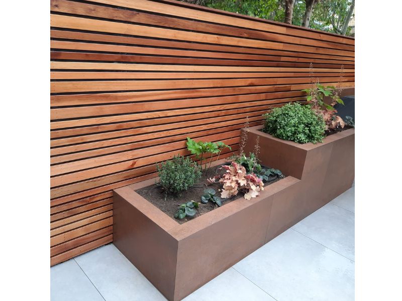 cedar batten fence with planters clad in x-tech porcelain cladding
