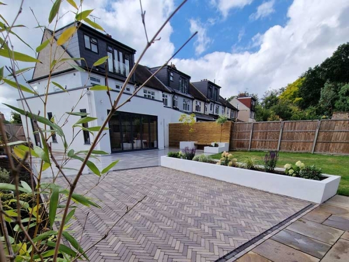 rear garden in Bromley with beautifully installed clay pavers and raised beds.