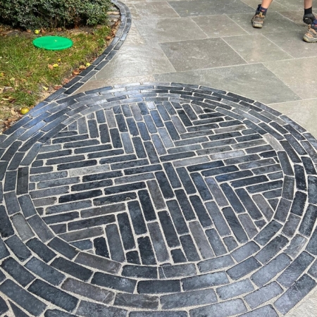 swirly pattern in paving made using limestone setts