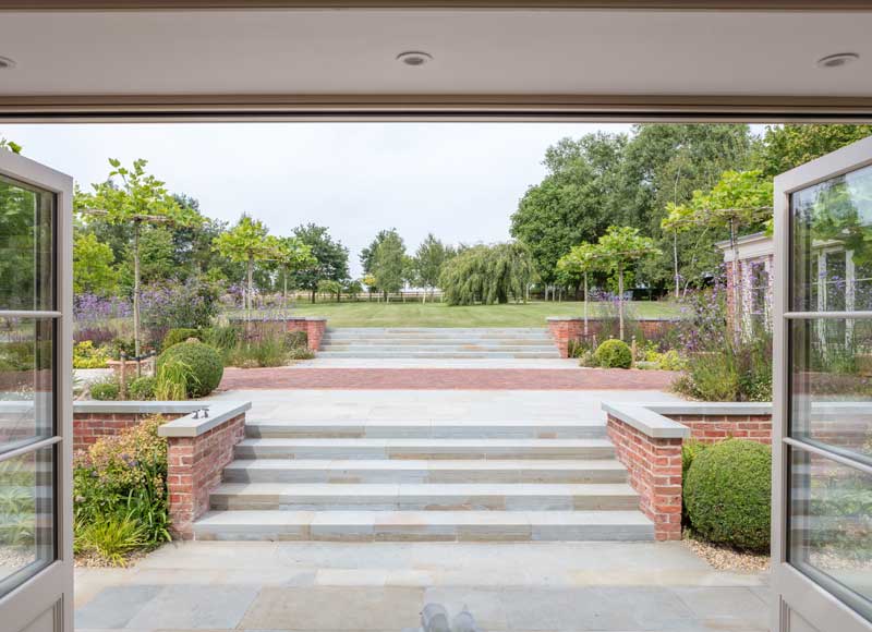 beautifully landscaped formal garden with UK sourced sandstone paving
