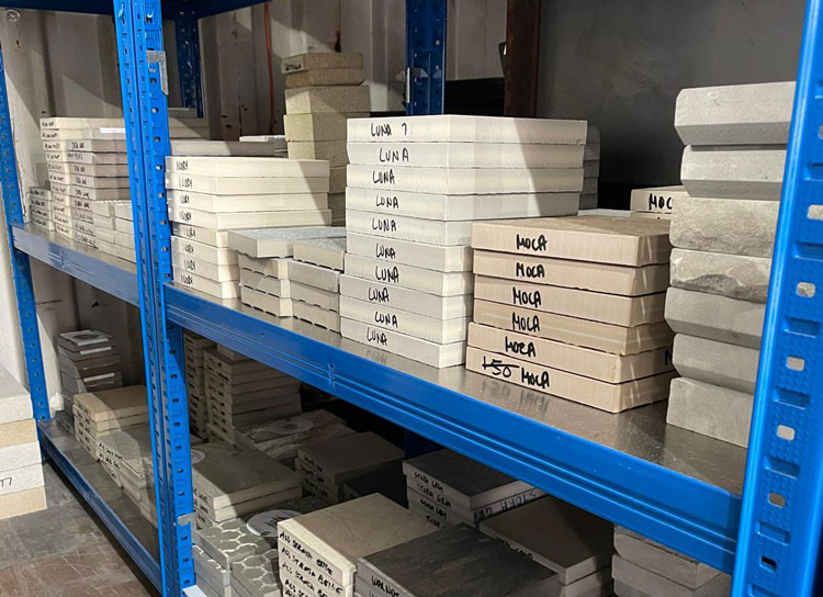 metal shelving stacked with samples of paving materials