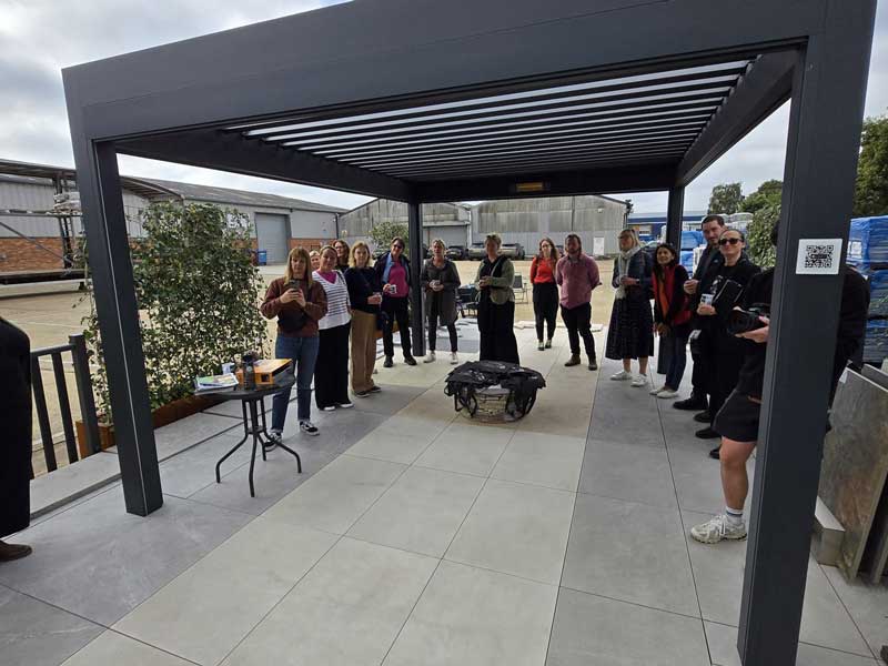 An assembly of garden designers beneath a Caribbean Blinds pergola