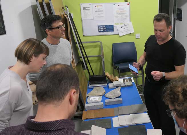 group of garden designers gathered around a table filled with landscaping samples