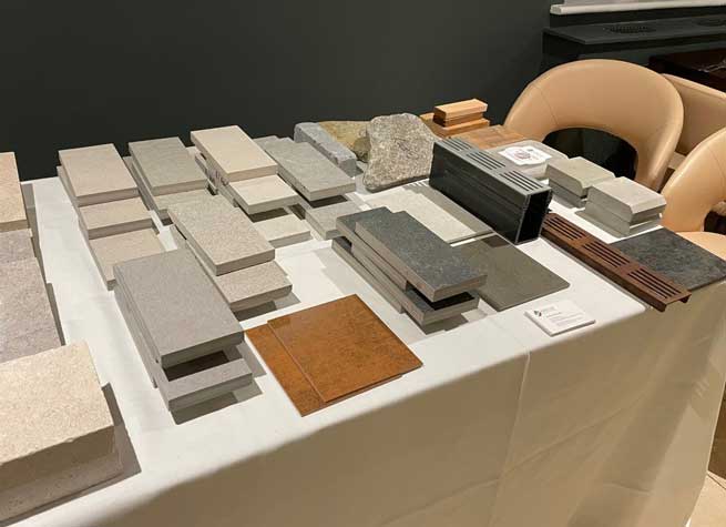 table spread with samples of porcelain paving and x-tech cladding in various colour ways