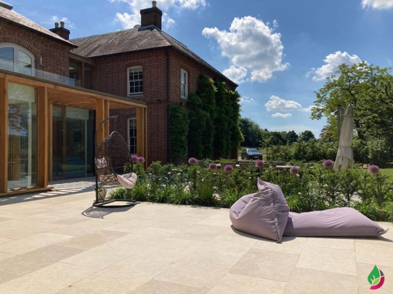 large garden terrace with outdoor beanbags resting on egyptian sinai pearl beige paving slabs