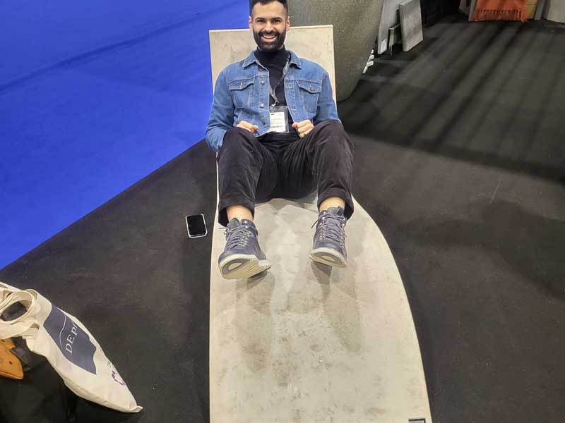 smiling man laying on lounger at landscaping trade show